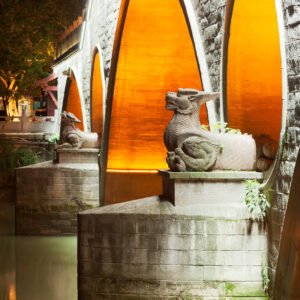 Two dragon statues at night on the Anshun bridge in Chengdu