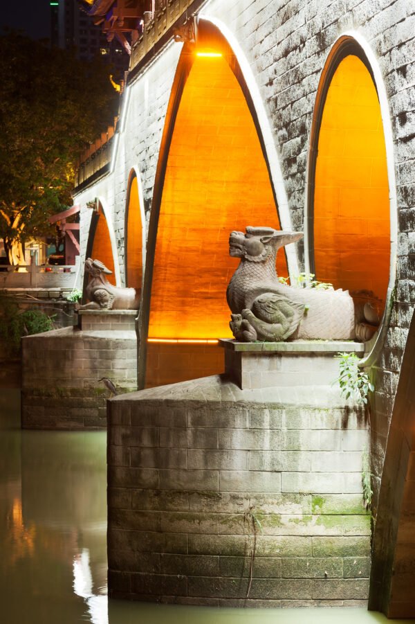 Two dragon statues at night on the Anshun bridge in Chengdu