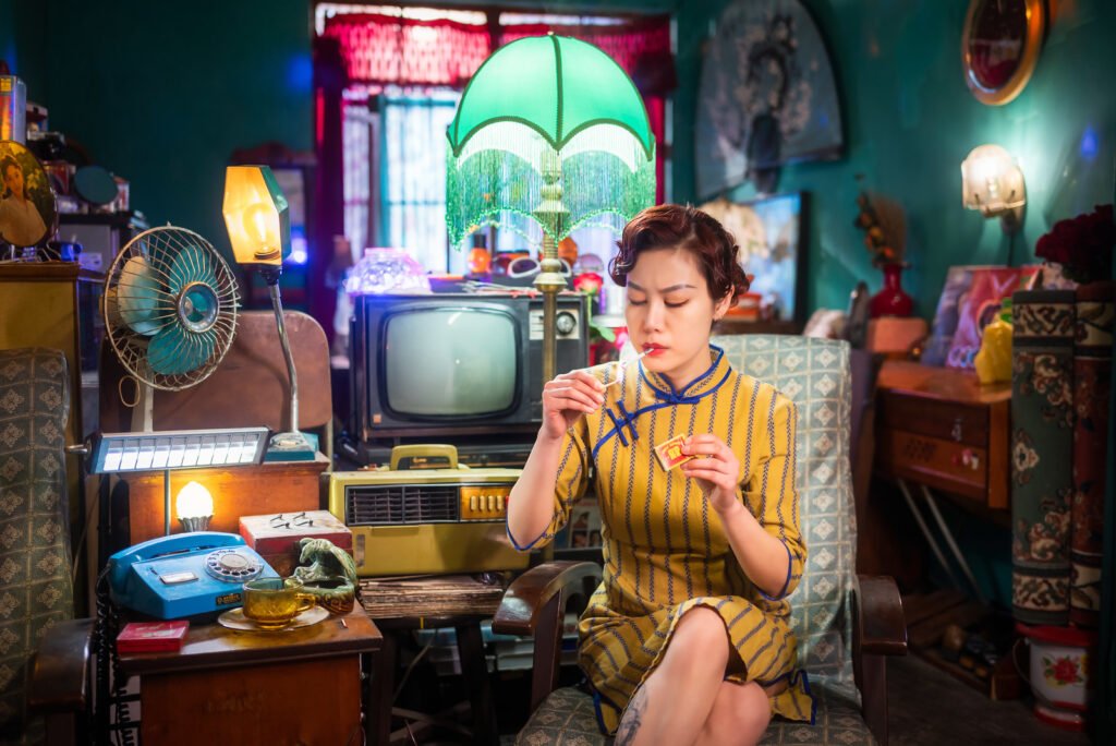 Young woman lighting a cigarette in a vintage appartment