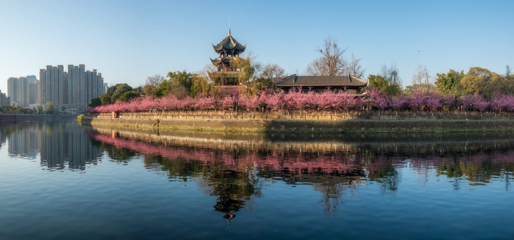 WangJiangLou pagoda with trees in bloom by the JinJiang river panorama in Chengdu