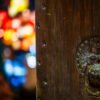 Chinese door knocker against chinese lanterns illuminated at night