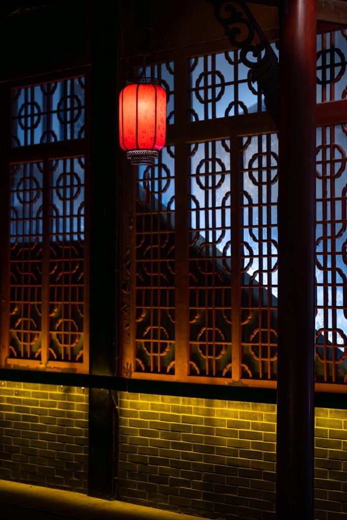 Red Chinese lantern against traditional window