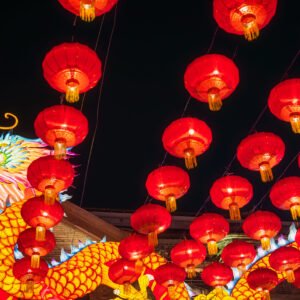 Dragon lanterns illuminated at night with red Chinese lanterns