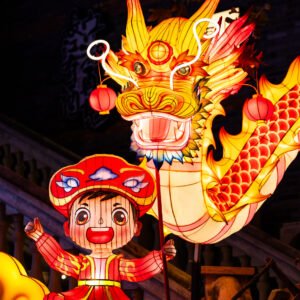 Dragon lanterns illuminated at night with red Chinese lanterns