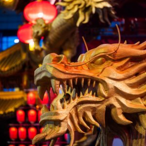 Dragon sculptures illuminated at night with red Chinese lanterns