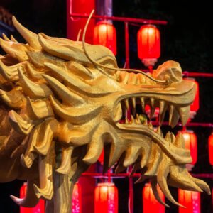Dragon sculpture illuminated at night with red Chinese lanterns