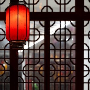 Red Chinese lantern against traditional window