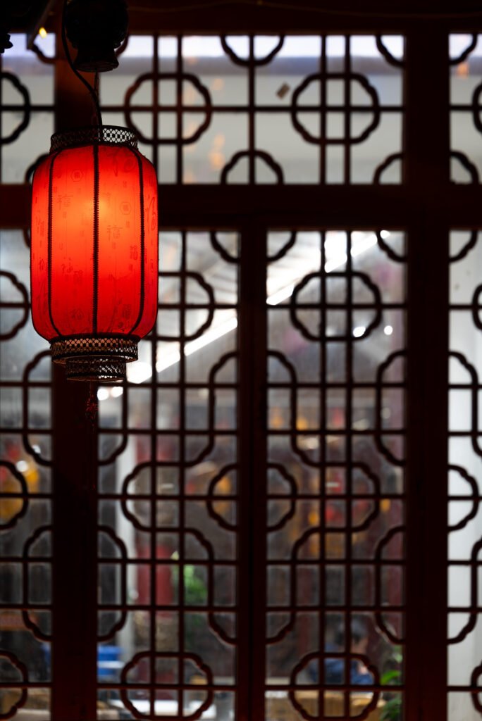 Red Chinese lantern against traditional window