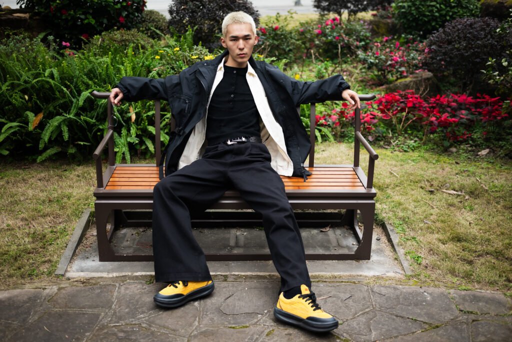 Portrait of a young Asian man in a park