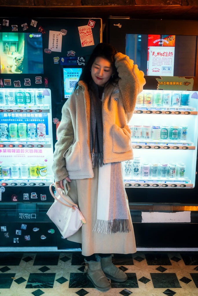 Young woman standing in front of a vending machine.