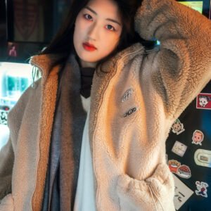 Young woman in a fuzzy coat standing in front of a vending machine.