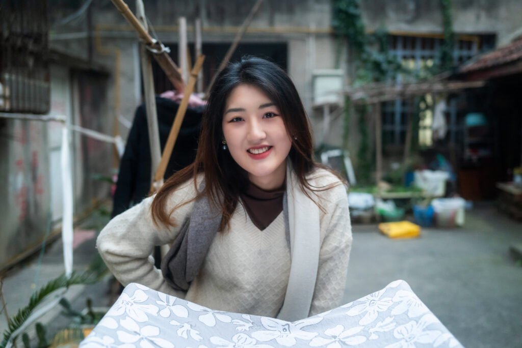 Portrait of a young woman smiling in a traditional Chinese courtyard