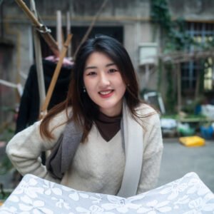 Portrait of a young woman smiling in a traditional Chinese courtyard