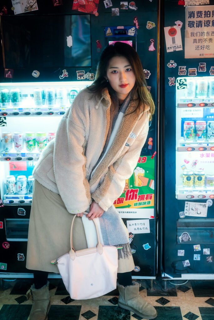 Young woman standing in front of a vending machine.