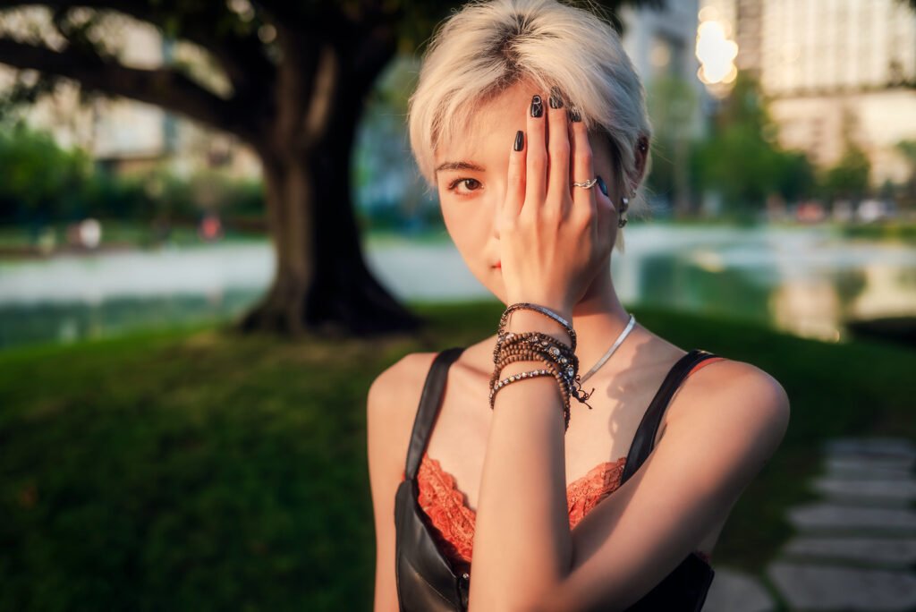 Blonde girl covering her face with her hand