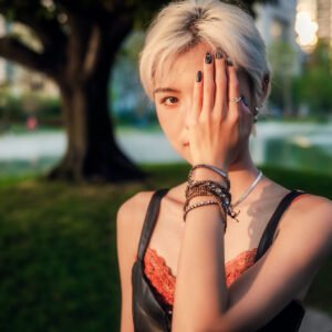 Blonde girl covering her face with her hand