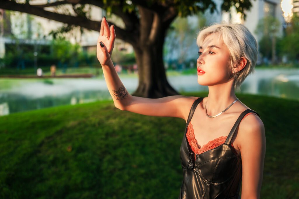 Blonde stylish girl enjoying the sunset in the park