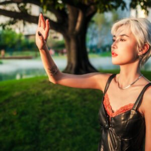 Blonde stylish girl enjoying the sunset in the park