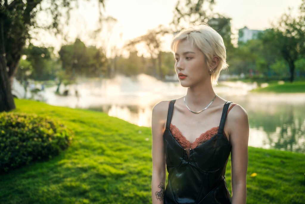 Blonde stylish girl posing in the park