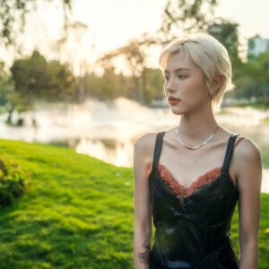 Blonde stylish girl posing in the park
