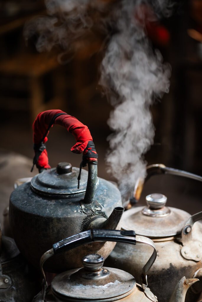 Old kettles with steam coming out of the spout