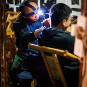 Man getting his ear cleaned with traditional Chinese tools in a tea house