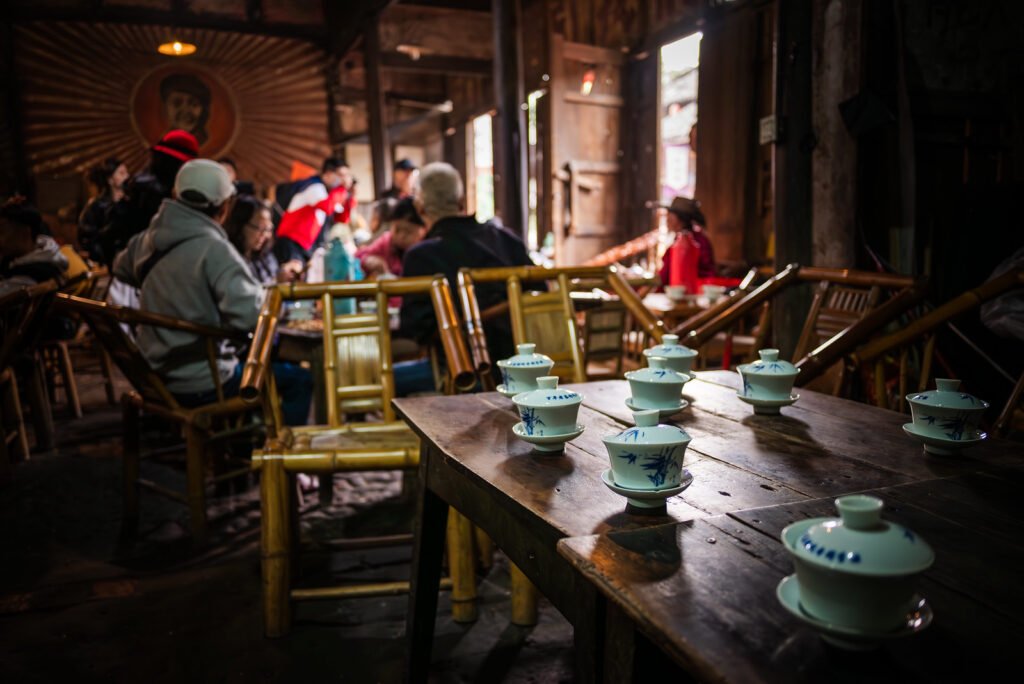 Rustic Chinese teahouse with bamboo chairs and blue and white porcelain teacups