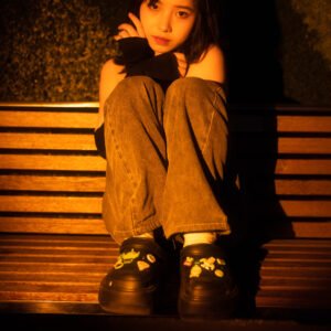 Lonely girl sitting on a bench at night