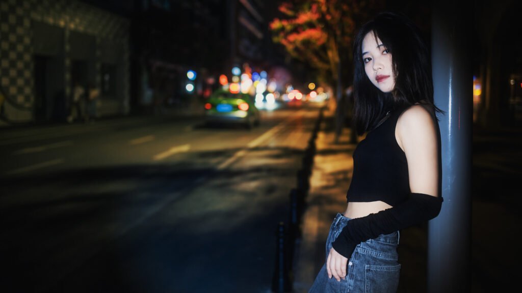 Night portrait of a young woman in the city