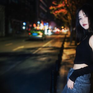 Night portrait of a young woman in the city