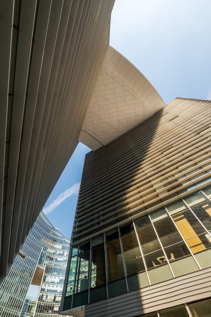 Modern curved buildings against clear blue sky