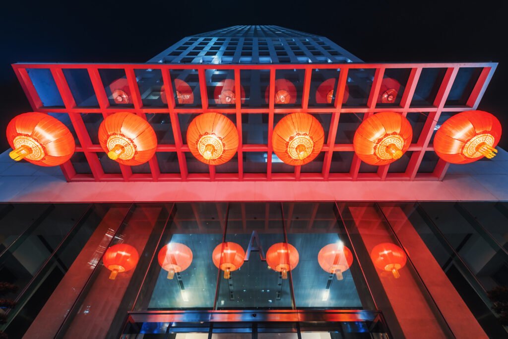 Red chinese lanterns hanging on a skyscraper low angle view