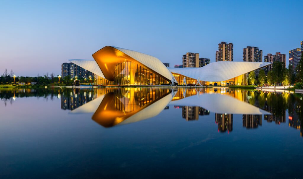 Chengdu Tianfu Art Museum reflecting in a lake at blue hour