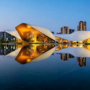 Chengdu Tianfu Art Museum reflecting in a lake at blue hour