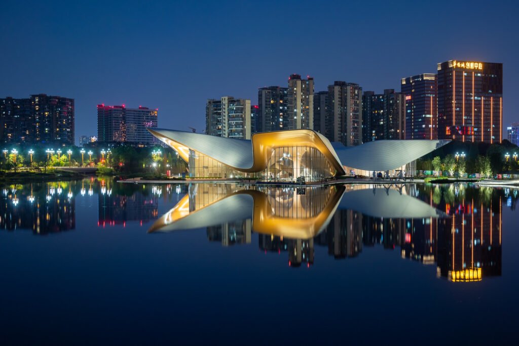 Chengdu Tianfu Art Museum reflecting in a lake at night