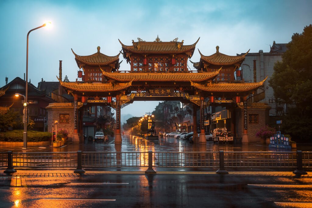 QinTailLu traditional Chinese gate under the rain at dusk in Chengdu
