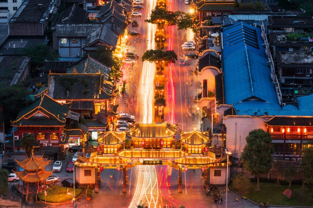 QinTaiLu chinese traditional gate illuminated at night aerial view with car light trails