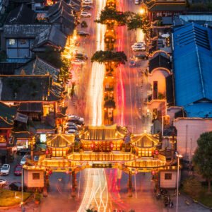 QinTaiLu chinese traditional gate illuminated at night aerial view with car light trails