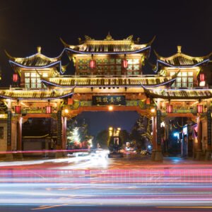 Qintailu traditional gate illminated at night with car traffic in the foreground - Chengdu