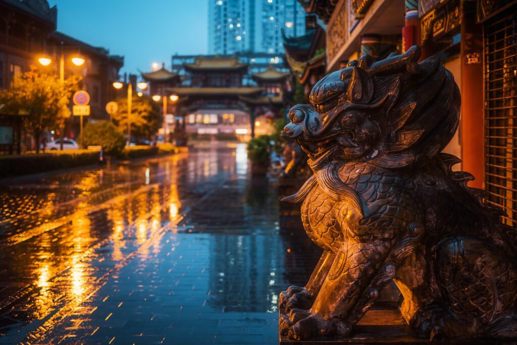 Dragon son bronze statue under the rain at dusk