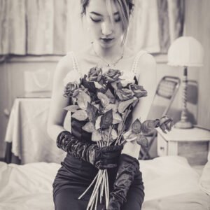 Lady in black dress with red roses.