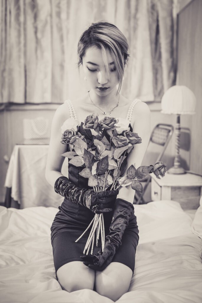 Lady in black dress with red roses.