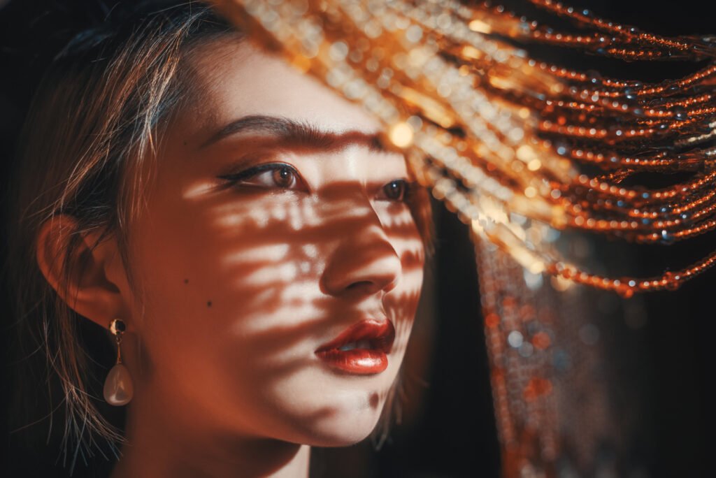 Portrait of a young woman with sunlight and shadows on her face