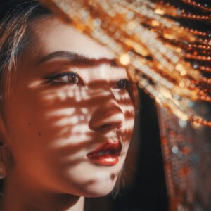 Portrait of a young woman with sunlight and shadows on her face