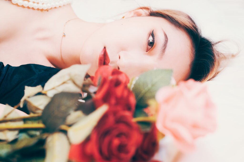 Beautiful woman sleeping on a bed of roses