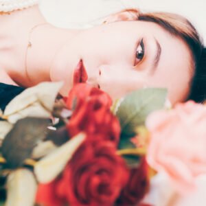 Beautiful woman sleeping on a bed of roses