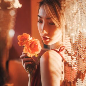 Portrait of a beautiful Asian woman holding a flower
