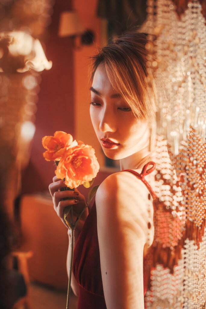 Portrait of a beautiful Asian woman holding a flower